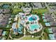 Stunning aerial view of community with pools, waterslides, clubhouse, tennis courts and manicured lawns at 7763 Westland Dr, Kissimmee, FL 34747