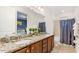 Bathroom with dual sinks, granite counters, wood cabinets and neutral color scheme at 7763 Westland Dr, Kissimmee, FL 34747