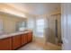 Bright bathroom features dual sinks, tub, and glass enclosed shower at 13910 Dove Wing Ct, Orlando, FL 32828