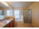 Well-lit bathroom features dual vanity, soaking tub, and glass-enclosed shower at 13910 Dove Wing Ct, Orlando, FL 32828