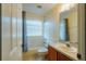 Well-lit bathroom with tub, shower, vanity and ample storage space at 13910 Dove Wing Ct, Orlando, FL 32828