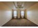 Carpeted bedroom with ceiling fan and large double windows at 13910 Dove Wing Ct, Orlando, FL 32828
