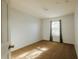 Neutral bedroom featuring carpet floors, natural lighting, and modern, neutral walls at 13910 Dove Wing Ct, Orlando, FL 32828