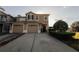 Inviting two-story home featuring a two-car garage, manicured landscaping, and a neatly paved driveway at 13910 Dove Wing Ct, Orlando, FL 32828