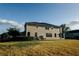 Back view of home featuring spacious yard and outdoor living at 13910 Dove Wing Ct, Orlando, FL 32828