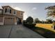 Charming two-story home showcasing a manicured lawn and a spacious driveway leading to a one-car garage at 13910 Dove Wing Ct, Orlando, FL 32828