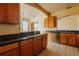 Kitchen with dark countertops and view of breakfast bar at 13910 Dove Wing Ct, Orlando, FL 32828