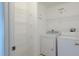 Efficient laundry room with shelving, washer, and dryer for added convenience at 13910 Dove Wing Ct, Orlando, FL 32828