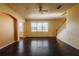 Bright living room with hardwood floors, a ceiling fan, and large windows allowing ample natural light at 13910 Dove Wing Ct, Orlando, FL 32828