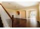 Spacious living room with hardwood floors, a staircase, and arched doorways leading to other rooms at 13910 Dove Wing Ct, Orlando, FL 32828