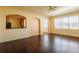 Inviting living room featuring hardwood floors, arched doorways, and large windows offering natural light at 13910 Dove Wing Ct, Orlando, FL 32828