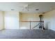 Spacious loft area with ample natural light, carpet flooring, and a ceiling fan at 13910 Dove Wing Ct, Orlando, FL 32828
