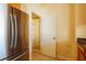 Pantry with shelving, conveniently located next to stainless steel refrigerator at 13910 Dove Wing Ct, Orlando, FL 32828