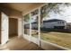 Charming screened patio area overlooking lush lawn and community residences at 13910 Dove Wing Ct, Orlando, FL 32828