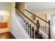 Elegant staircase featuring wooden railings, white spindles, and dark wood steps leading to the upper level at 13910 Dove Wing Ct, Orlando, FL 32828