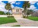 Two-story house with palm trees and a large yard at 14331 Bending Branch Ct, Orlando, FL 32824