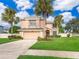 Two-story house with palm trees and a large yard at 14331 Bending Branch Ct, Orlando, FL 32824