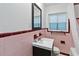 Charming bathroom featuring pink tile, a mirror, and a vanity at 2341 Devon Ct, Winter Park, FL 32789