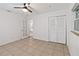 Cozy bedroom featuring tile floors, a ceiling fan, and closet at 2341 Devon Ct, Winter Park, FL 32789