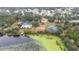 Community overview showing homes, a pool, tennis courts, and a lake at 2402 Sw 20Th Ter, Ocala, FL 34471