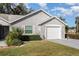 Single-story home with attached garage and well-manicured lawn at 2402 Sw 20Th Ter, Ocala, FL 34471