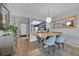 Modern dining area with light wood table and blue chairs at 4109 Fairview Vista Pt # 219, Orlando, FL 32804