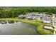 An aerial view shows a community with homes on landscaped lots around a picturesque lake at 11218 Pixie Mandarin Ct, Winter Garden, FL 34787