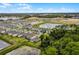 Aerial view of a community showcasing new construction homes, lush landscaping, and scenic ponds at 11218 Pixie Mandarin Ct, Winter Garden, FL 34787