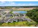 Aerial view of a Primary-planned community with modern homes, scenic ponds, and expansive green spaces at 11218 Pixie Mandarin Ct, Winter Garden, FL 34787