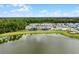 An aerial view displays the community homes backing to the lake, with well-maintained lawns at 11218 Pixie Mandarin Ct, Winter Garden, FL 34787