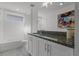 Stylish bathroom with a sleek vanity, bathtub, and a large Mickey Mouse inspired art piece at 11218 Pixie Mandarin Ct, Winter Garden, FL 34787