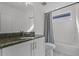 Bright bathroom featuring granite counters, sleek fixtures, and a shower-tub combination at 11218 Pixie Mandarin Ct, Winter Garden, FL 34787