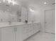 Elegant bathroom featuring double sinks, white marble tile flooring, and a glass-enclosed shower at 11218 Pixie Mandarin Ct, Winter Garden, FL 34787