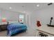 Unique bedroom space with a bright blue themed bed and a desk and chair combo for work at 11218 Pixie Mandarin Ct, Winter Garden, FL 34787