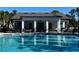 A view from the community pool highlighting the open-air clubhouse with BBQ grills at 11218 Pixie Mandarin Ct, Winter Garden, FL 34787