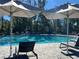 Inviting community pool with comfortable lounge chairs and shade umbrellas for relaxing poolside at 11218 Pixie Mandarin Ct, Winter Garden, FL 34787