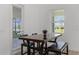 Bright dining area with modern table and seating, adjacent to screened patio entrance at 11218 Pixie Mandarin Ct, Winter Garden, FL 34787
