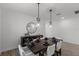 Well-lit dining room with decorative mirror, table set for six, and contemporary decor at 11218 Pixie Mandarin Ct, Winter Garden, FL 34787