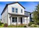 Two-story home featuring a covered porch with white pillars and tidy landscaping at 11218 Pixie Mandarin Ct, Winter Garden, FL 34787