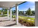 Inviting front porch with grey pillars, brick flooring, and lush landscaping at 11218 Pixie Mandarin Ct, Winter Garden, FL 34787