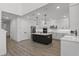 Modern kitchen boasts white cabinetry, stainless steel appliances, and a large center island at 11218 Pixie Mandarin Ct, Winter Garden, FL 34787