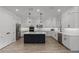 Bright kitchen features white cabinets, modern appliances and a black center island at 11218 Pixie Mandarin Ct, Winter Garden, FL 34787