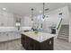 Well-lit modern kitchen with a center island, stainless appliances, and a view into the living area at 11218 Pixie Mandarin Ct, Winter Garden, FL 34787