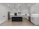 Bright kitchen featuring white cabinets, a contrasting dark island, stainless appliances, and sleek countertops at 11218 Pixie Mandarin Ct, Winter Garden, FL 34787