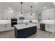 Modern kitchen with stainless steel appliances, white countertops and a black center island at 11218 Pixie Mandarin Ct, Winter Garden, FL 34787