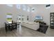 Bright living room with soaring ceilings, oversized sofa, and backyard access at 11218 Pixie Mandarin Ct, Winter Garden, FL 34787