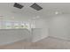Open loft space with neutral carpet, bright natural light, and views of the neighborhood at 11218 Pixie Mandarin Ct, Winter Garden, FL 34787