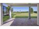 Open-air patio with brick pavers offers panoramic views of the lush green backyard and clear blue sky at 11218 Pixie Mandarin Ct, Winter Garden, FL 34787