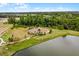 An aerial view showcases the community playground and the lake at 11218 Pixie Mandarin Ct, Winter Garden, FL 34787