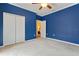 Bedroom with ceiling fan and double closet at 1221 Glendora N Rd, Kissimmee, FL 34759